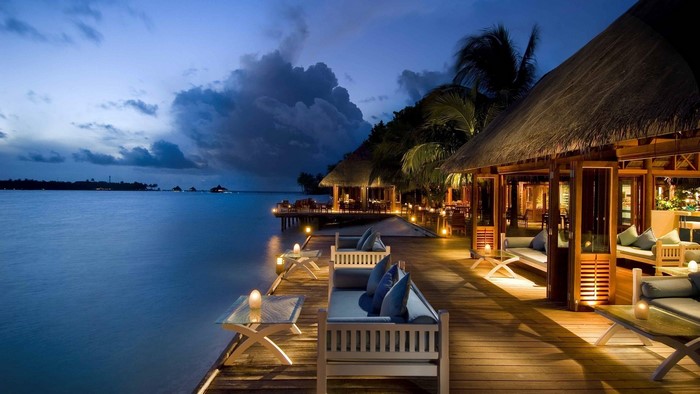 Tropical resort overwater bungalows at dusk