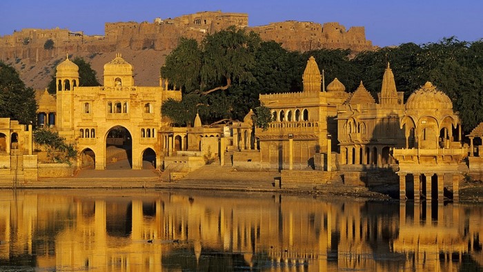 Golden fort and temples reflected in water