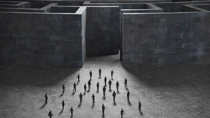 People entering a giant stone labyrinth