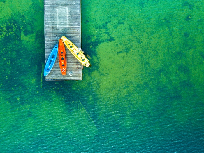 Colorful Kayaks on a Wooden Dock Overlooking a Lake
