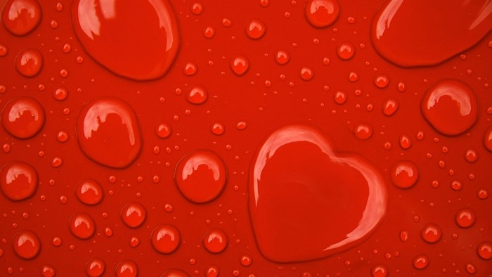 Red Heart Shape Water Droplets on Red Surface