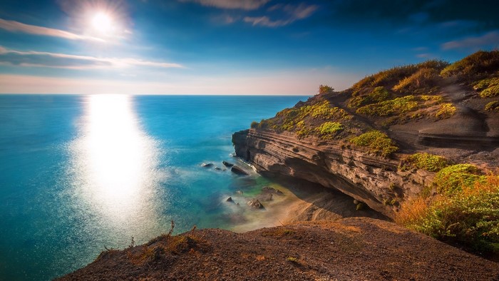 Sunlit Sea and Rocky Coastline in France