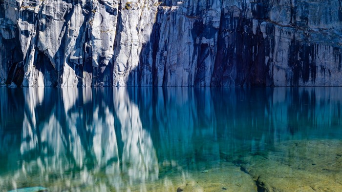 Precipice Lake with Rocky Cliffs and Reflection