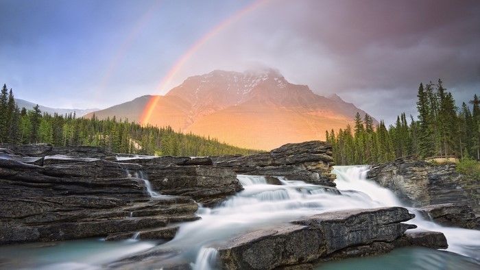 Rainbow over a mountain and waterfall
