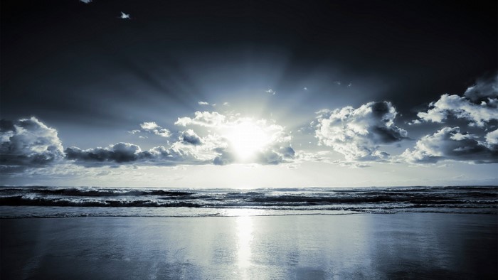 Dark Sunrise Over Ocean Waves
