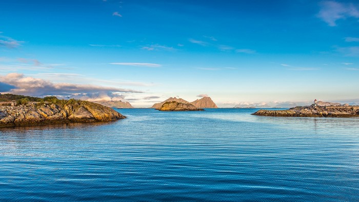 Sea and Islands with Lighthouse under Blue Sky