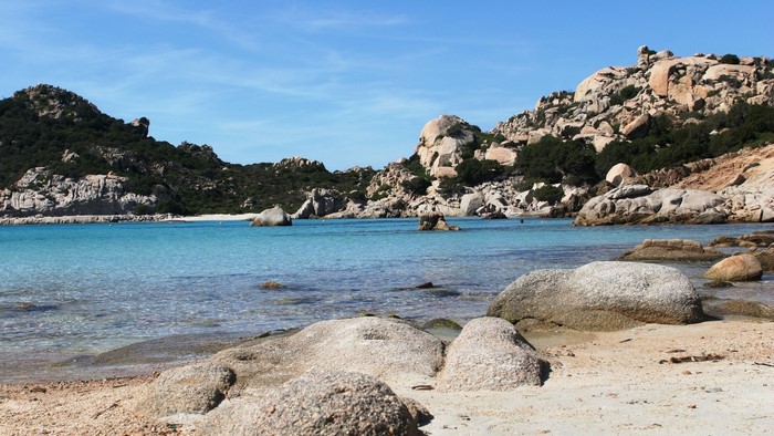 Beach in Italy with rocky hills and clear blue water