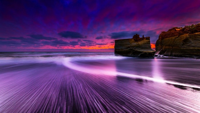 Purple Beach Sunset with Rock Formations