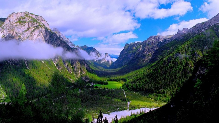 Green Valley with Mountains and Clouds