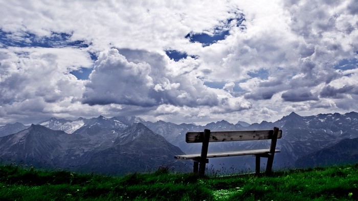 Wooden bench overlooking mountain range