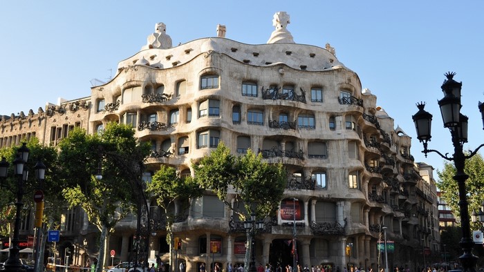 La Pedrera building with trees and street lamps