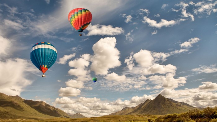 Hot Air Balloons Over Mountains