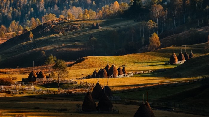 Haystacks in a Romanian countryside during autumn