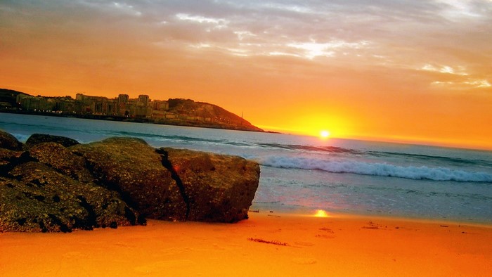 Golden Beach Sunset Overlooking City