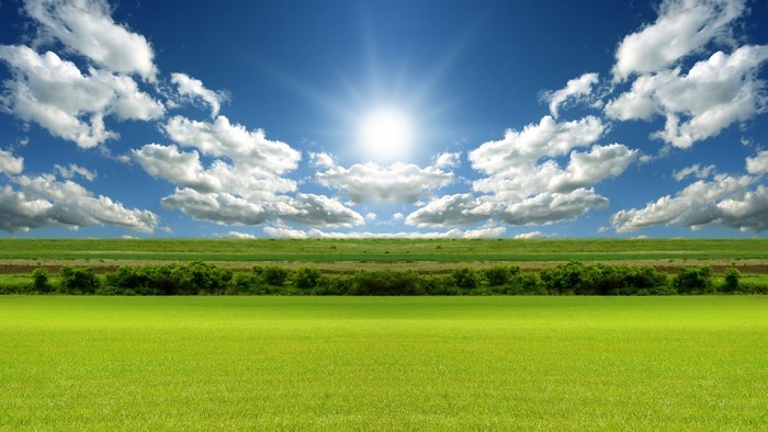 Bright Sunny Day with Clouds Over Green Fields