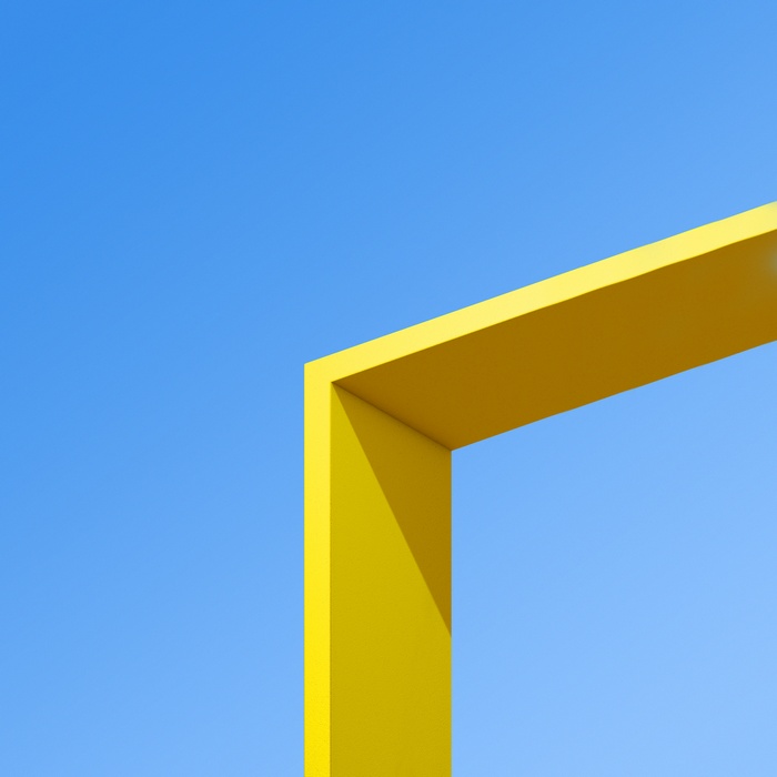 Yellow structure against a clear blue sky
