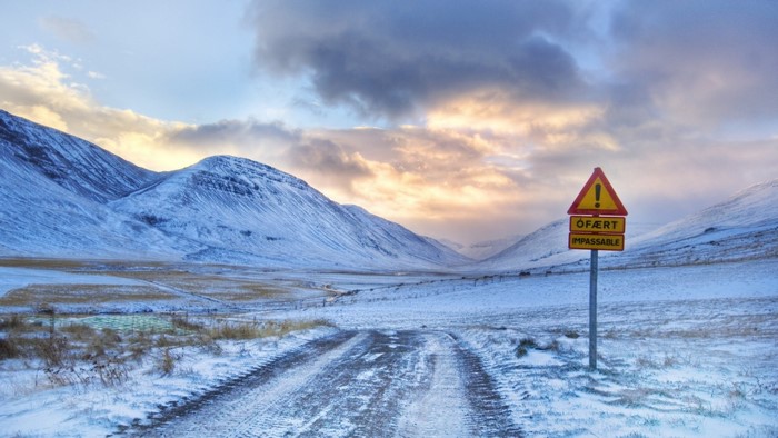 Impassable road sign in a snowy mountain valley