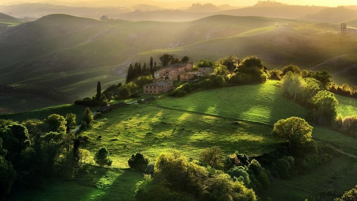 Green hills with a villa at sunset
