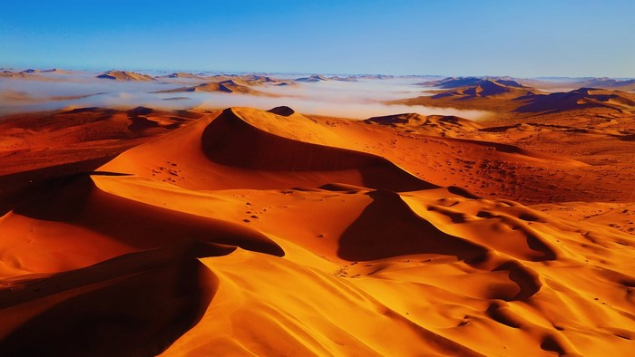 Golden Sand Dunes in Desert with Fog
