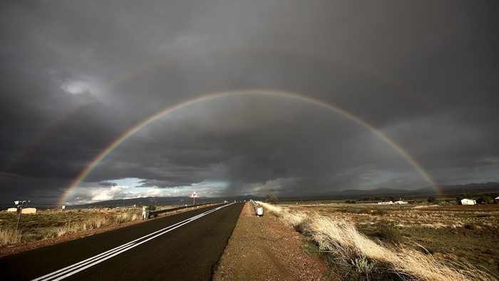 Double rainbow over a rural road