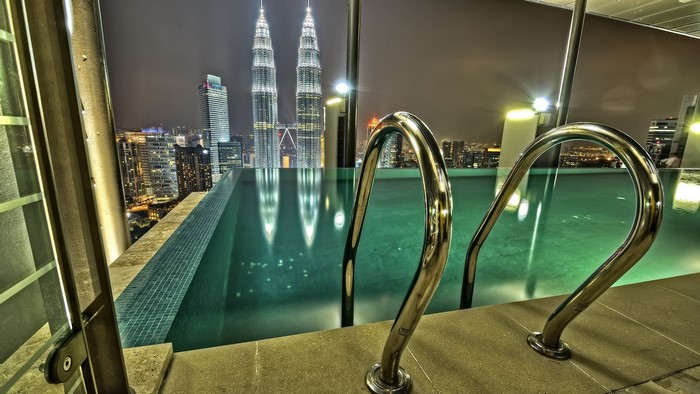 Infinity pool overlooking Kuala Lumpur skyline at night