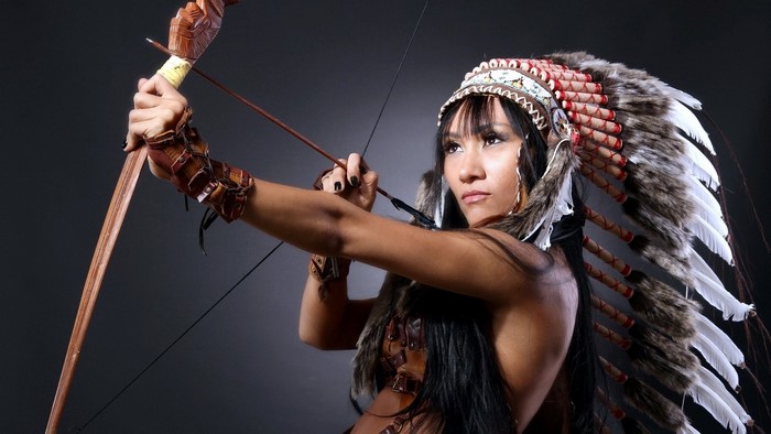Woman in Native American Headdress with Bow and Arrow