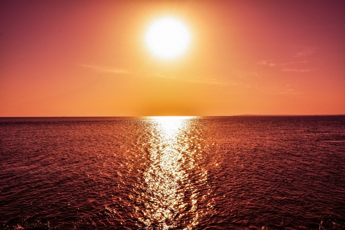 Sunset over the sea with reflections