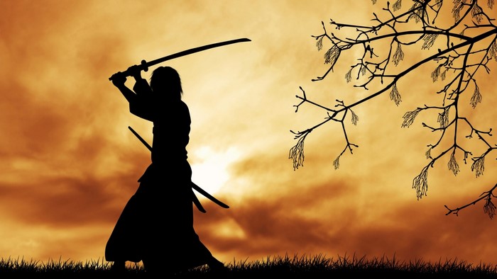 Samurai warrior with katana at sunset