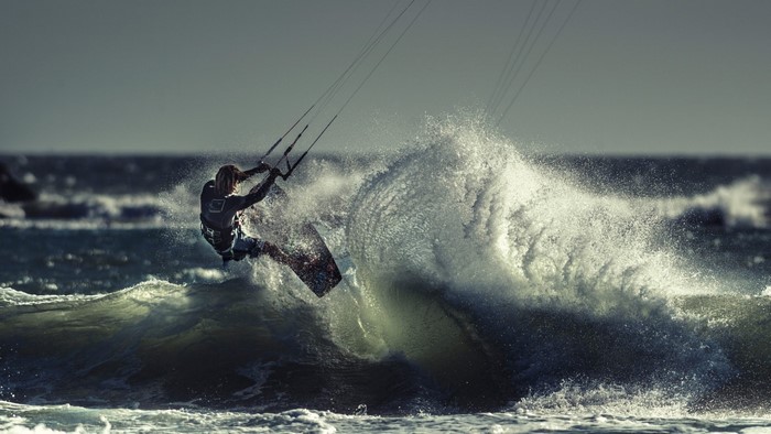 Kite surfer riding a wave