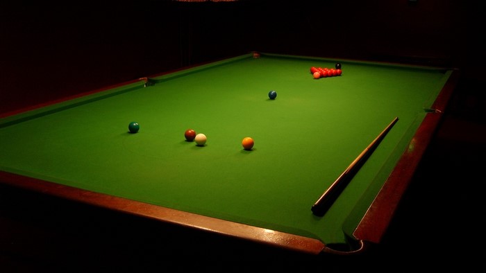 Snooker table with balls and cue