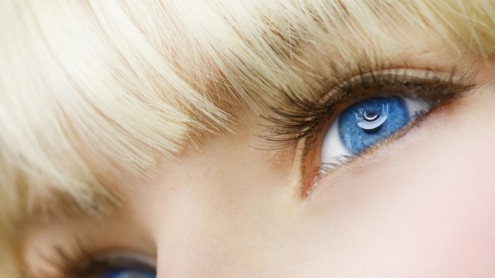 Close-up of a blonde girl's blue eye