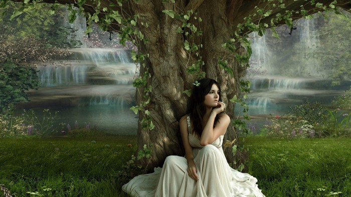 Girl in a white dress under a tree with waterfalls