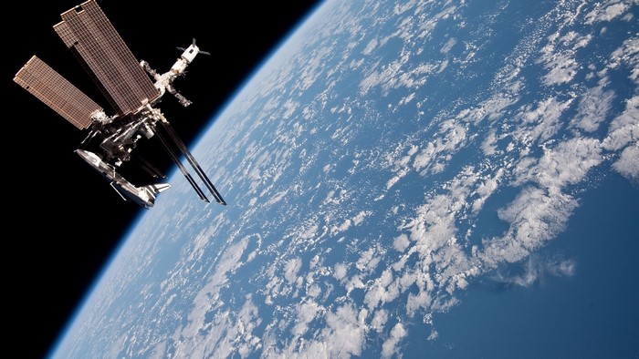 Space Shuttle and International Space Station above Earth