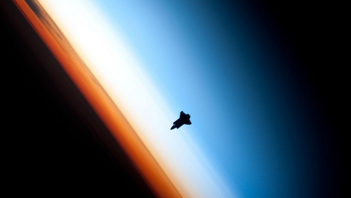 Space Shuttle Orbiting Earth Atmosphere