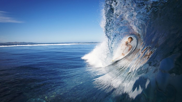 Female surfer inside a wave barrel