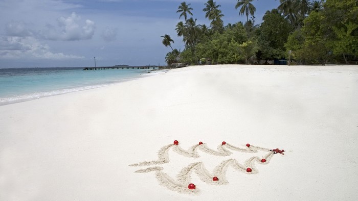 Christmas Tree Drawn in Sand with Ornaments on Tropical Beach