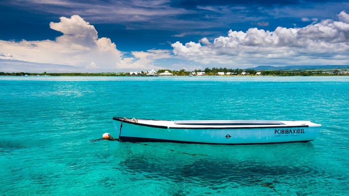 White boat floating in clear turquoise water