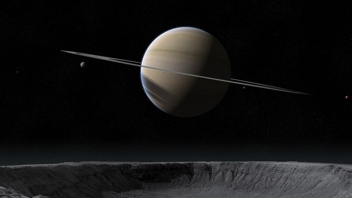 Saturn and its moons from a cratered surface