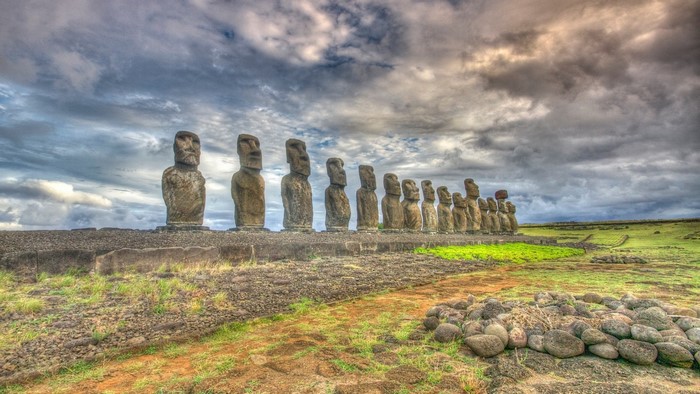 Moai statues on Easter Island under a cloudy sky