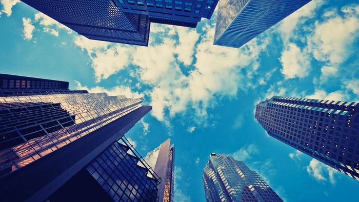 Skyscrapers against a blue sky with clouds