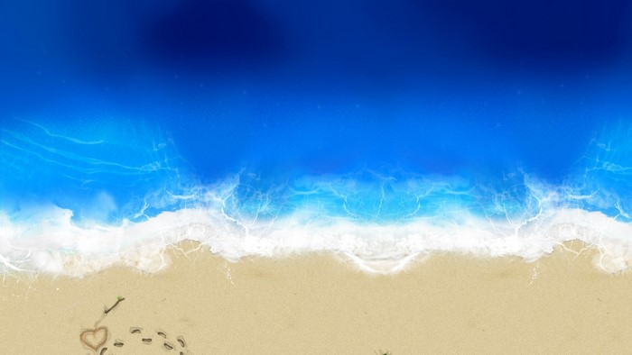 Heart drawn in sand with footprints and ocean waves