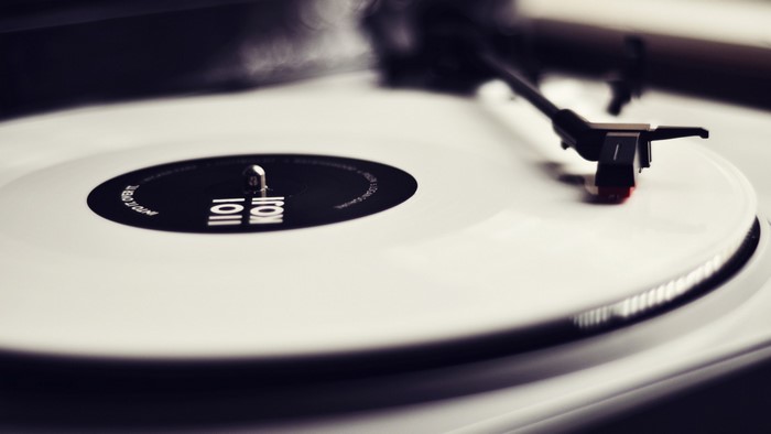 White vinyl record on a turntable with a stylus