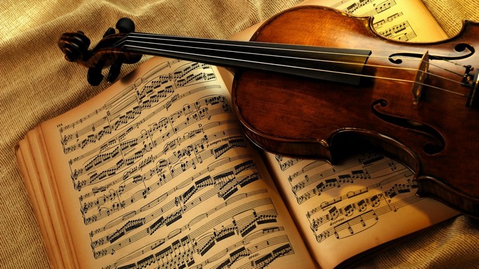 Violin resting on sheet music