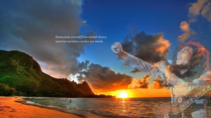 Bob Marley performing on a beach at sunset