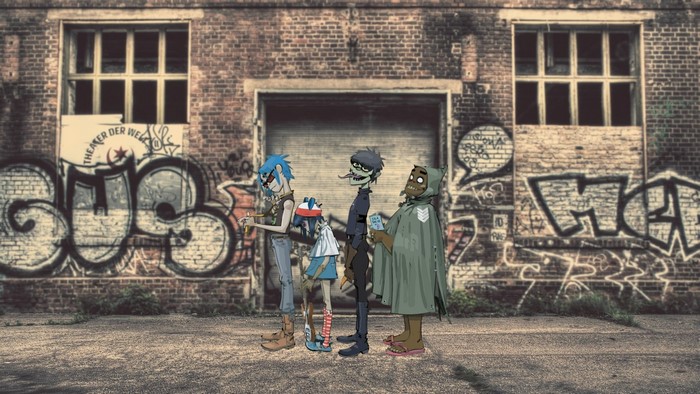 Gorillaz characters in front of graffiti-covered building