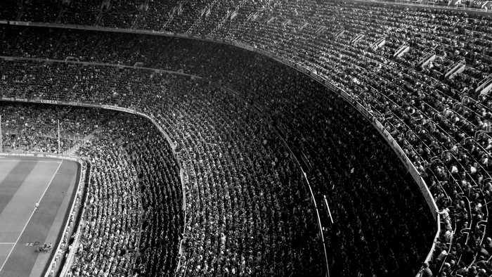 Black and white image of a crowded soccer stadium