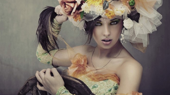 Woman with elaborate floral headdress and green dress