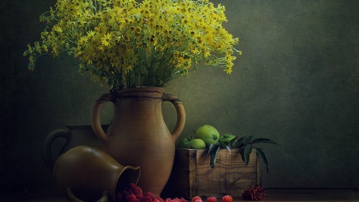 Still life with yellow flowers, berries, and apples