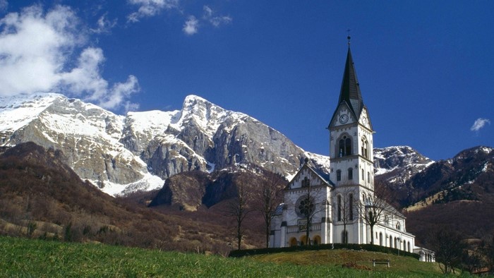 Church in Dreznica with Snow-Capped Mountains