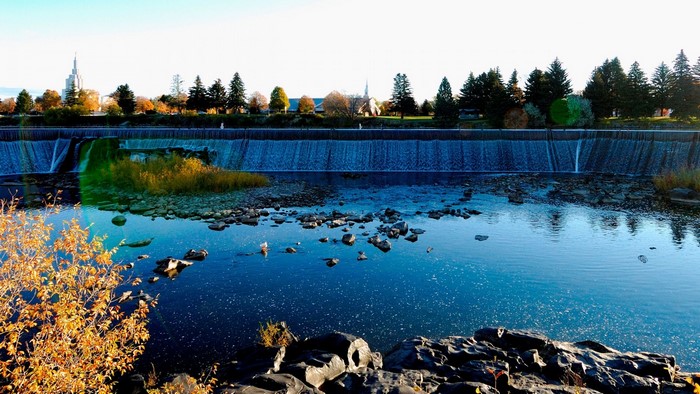 Dam with waterfall and trees